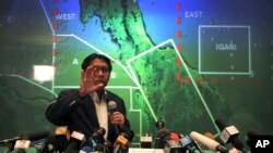 FILE - Malaysia's Department of Civil Aviation's Director General Azharuddin Abdul Rahman briefs reporters on search and recovery efforts within existing and new areas for missing Malaysia Airlines plane during a press conference, Monday, March 10, 2014 in Sepang, Malaysia.