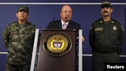 FILE - Colombia's Defense Minister Luis Carlos Villegas (C) delivers a speech during a news conference in Bogota, Oct. 26, 2015.