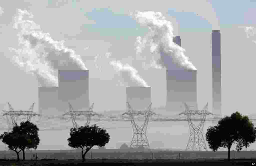 FILE - Smoke billows from the chimneys at Lethabo Power Station, a coal-fired power station, in Vereeniging, South Africa, Dec. 5, 2018.
