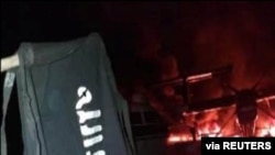 FILE - An image distributed by al-Shabab after an attack on a military base in Kenya shows the militant group's flag, said to be at the Manda Bay Airfield in Manda, Lamu, Kenya, Jan. 5, 2020. 