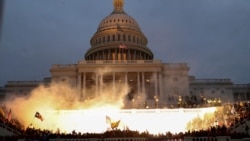 An explosion caused by a police munition is seen while supporters of U.S. President Donald Trump gather in front of the U.S. Capitol Building in Washington, U.S., Jan. 6, 2021.