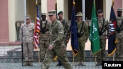 FILE - Commander of NATO Resolute Support forces and United States forces in Afghanistan, U.S. Army General John Nicholson walks during a change of command ceremony in Resolute Support headquarters in Kabul, Afghanistan, March 2, 2016.
