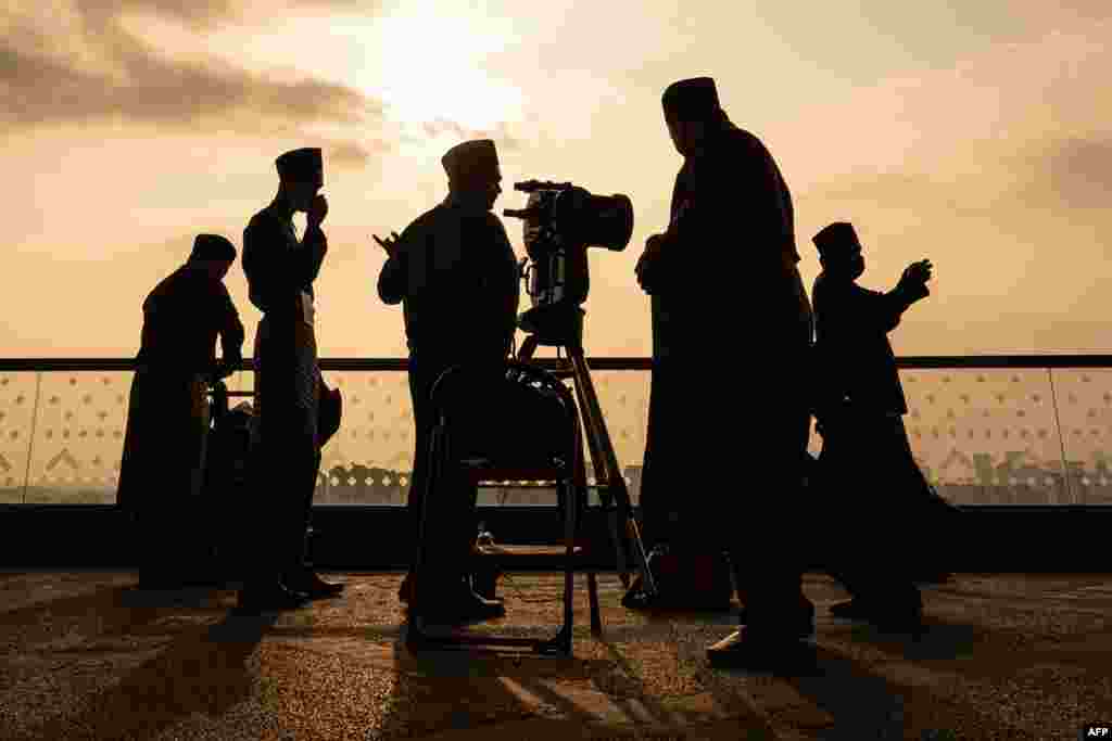 An official uses a telescope to perform "rukyah", the sighting of the new moon for the Muslim holy fasting month of Ramadan, in Putrajaya, Malaysia.