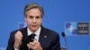 FILE PHOTO: U.S. Secretary of State Antony Blinken removes his mask as he gives a press briefing at the end of a NATO Foreign Ministers' meeting at the Alliance's headquarters in Brussels, Belgium, March 24, 2021. 