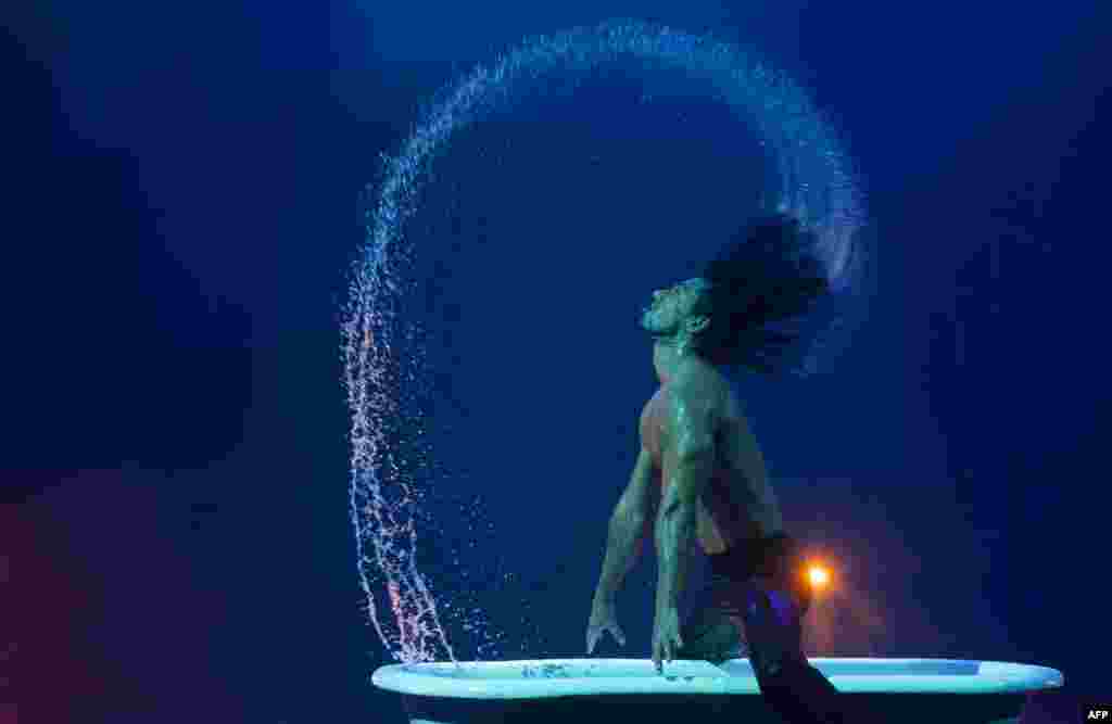 An acrobat performs during a press rehearsal of the new musical show "The Hole X" in Madrid, Spain.