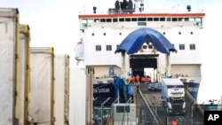 FILE - Lorries and cars disembark from a ferry arriving from Scotland at the P&O ferry terminal in the port at Larne on the north coast of Northern Ireland, Jan. 1, 2021, the first day after Britain's Brexit split with the European Union.