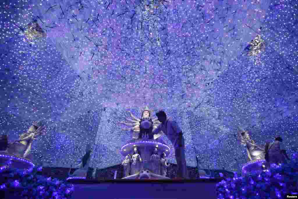Artisan Rintu Das applies finishing touches to an idol of the Hindu goddess Durga inside a marquee, ahead of the Durga Puja festival, in Kolkata, India. The festival, which will be celebrated from Oct. 11 to 14, is the biggest religious event for Bengali Hindus. Hindus believe that the goddess Durga symbolises power and the triumph of good over evil.