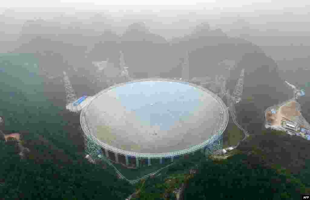 The Five-hundred-meter Aperture Spherical Radio Telescope (FAST) is seen on its first day of operation in Pingtang, in southwestern China's Guizhou province.