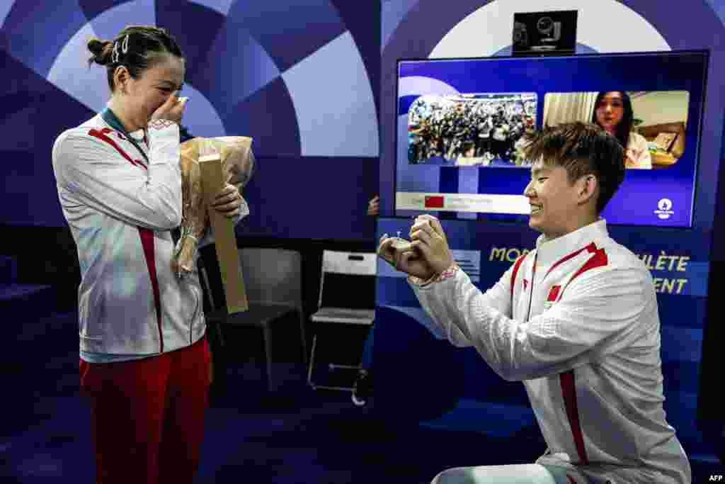 China's Gold medalist Huang Ya Qiong reacts as she receives a marriage proposal from her partner Liu Yuchen after leaving the podium at the mixed doubles badminton medal ceremony during the Paris 2024 Olympic Games at Porte de la Chapelle Arena in Paris, France, Aug. 2, 2024.