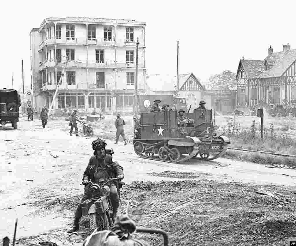 Following the first Allied landings on the French coast troops began to move inland, passing through villages where they were given a warm welcome, June 6, 1944.