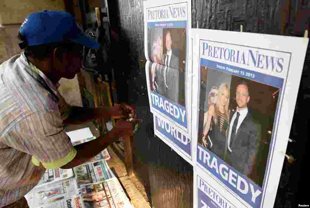 A newspaper vendor sets up his stall outside court ahead of Pistorius' court appearance in Pretoria, February 15, 2013.