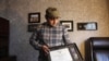 In this Monday, Dec. 16, 2019, photo, Zia Ghafoori displays the Purple Heart at his home in Charlotte, N.C., that he received while working with U.S. Forces in Afghanistan.