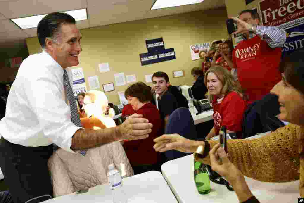 Mitt Romney greets campaign workers during a visit to a voter call center in Green Tree, Pennsylvania.