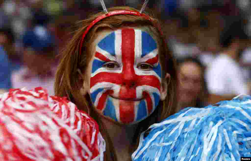 A Britain fan, with her face painted in the style of the Union Jack, smiles while attending the men's Group A football match against Senegal at the London 2012 Olympic Games in Old Trafford, Manchester, northern England July 26, 2012.