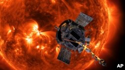 This image made available by NASA shows an artist's rendering of the Parker Solar Probe approaching the Sun. It's designed to take solar punishment like never before, thanks to its revolutionary heat shield that’s capable of withstanding 2,500 degrees Fahrenheit (1,370 degrees Celsius).