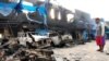 A man looks at damaged vehicles in front of Indonesia's Customs and Excise Office after a riot in Jayapura, Papua, Indonesia, Aug. 30, 2019, in this photo taken by Antara Foto. 