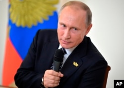 FILE - Russian President Vladimir Putin speaks to Russian journalists during a news conference, Oct. 16, 2016.
