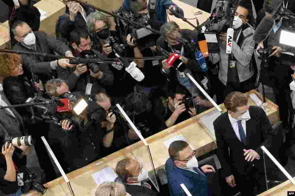 Sebastian Kurz, bottom right, leader of Austria's People's party and the party's parliamentary group leader, who recently resigned as Austrian Chancellor over a media corruption scandal, arrives to attend the parliamentary session at the Austrian Parliament in Vienna, Austria.