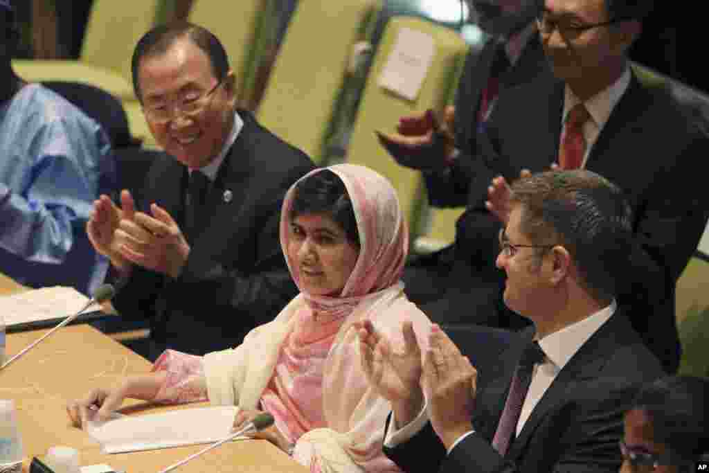 United Nations Secretary-General Ban Ki-moon, left, applauds as the members of the ‘Malala Day’ Youth Assembly wish Malala Yousafzai, center, a happy birthday, July 12, 2013 at United Nations headquarters.