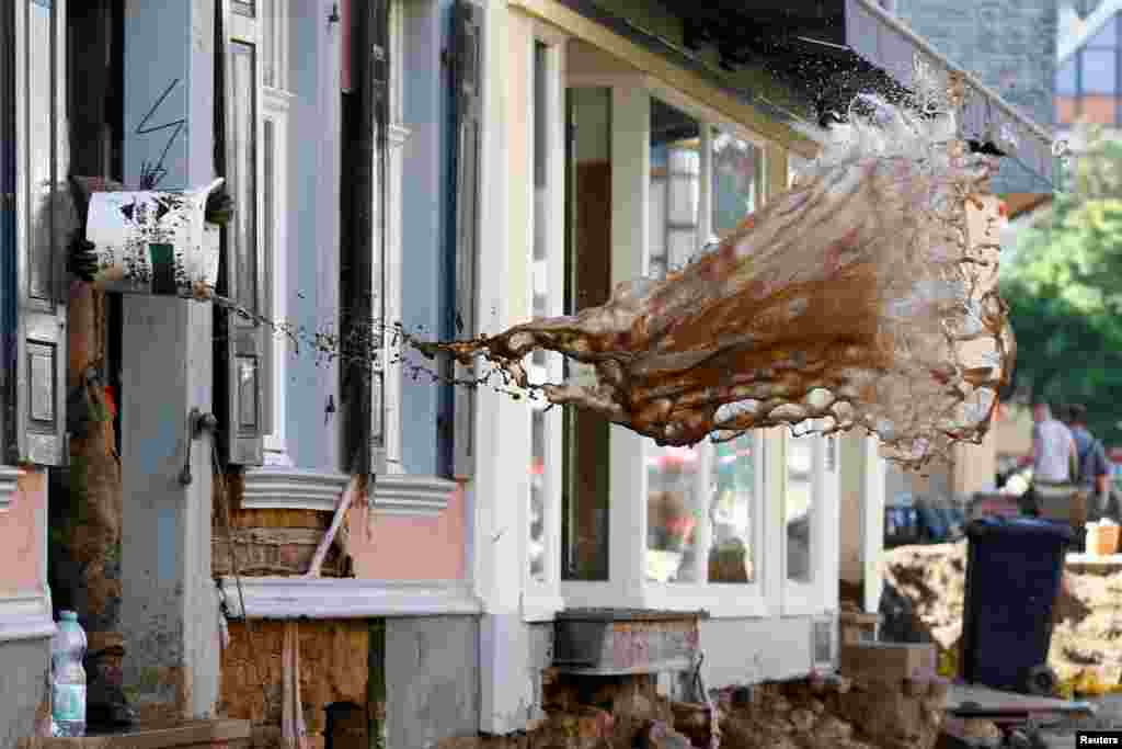 A soldier throws water out of a house, following heavy rainfalls, in Bad Muenstereifel, North Rhine-Westphalia state, Germany.