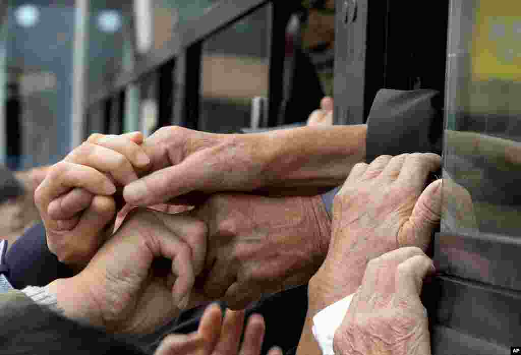 South Koreans and their North Korean relatives grip hands to bid farewell after the Separated Family Reunion Meeting at Diamond Mountain resort in North Korea, Oct. 22, 2015.