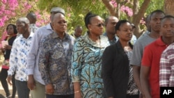 The ruling party CCM presidential candidate Dr. John Magufuli, third left, stands in line to cast his vote at Chamwino in Dodoma, Oct. 28, 2020.