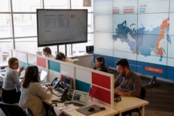 FILE - Activist supporters of Kremlin critic Alexei Navalny are seen monitoring elections at the office of Navalny's Anti-Corruption Foundation (FBK), in Moscow, Russia, March 18, 2018.