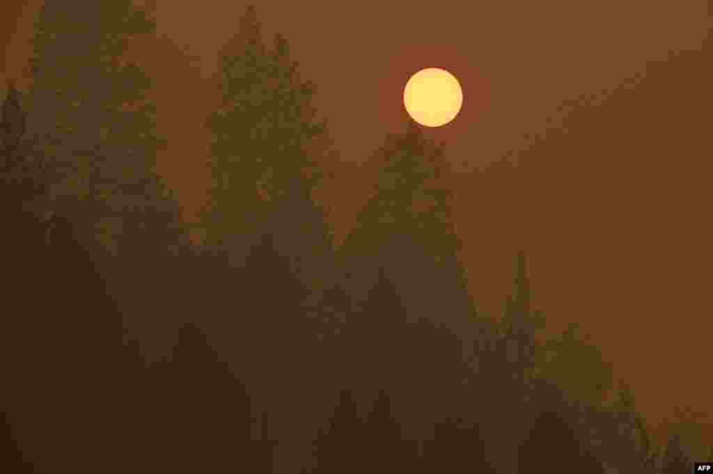 Light from the setting sun is filtered through smoke from the Dixie Fire, in Twain, California on July 26, 2021.