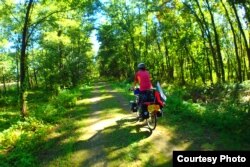 Yana flies her handmade Bulgarian flag on her bicycle