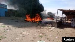 A bonfire is lit along the street during protests against price increases in Atbara, Nile River state in northeastern Sudan Dec. 20, 2018.