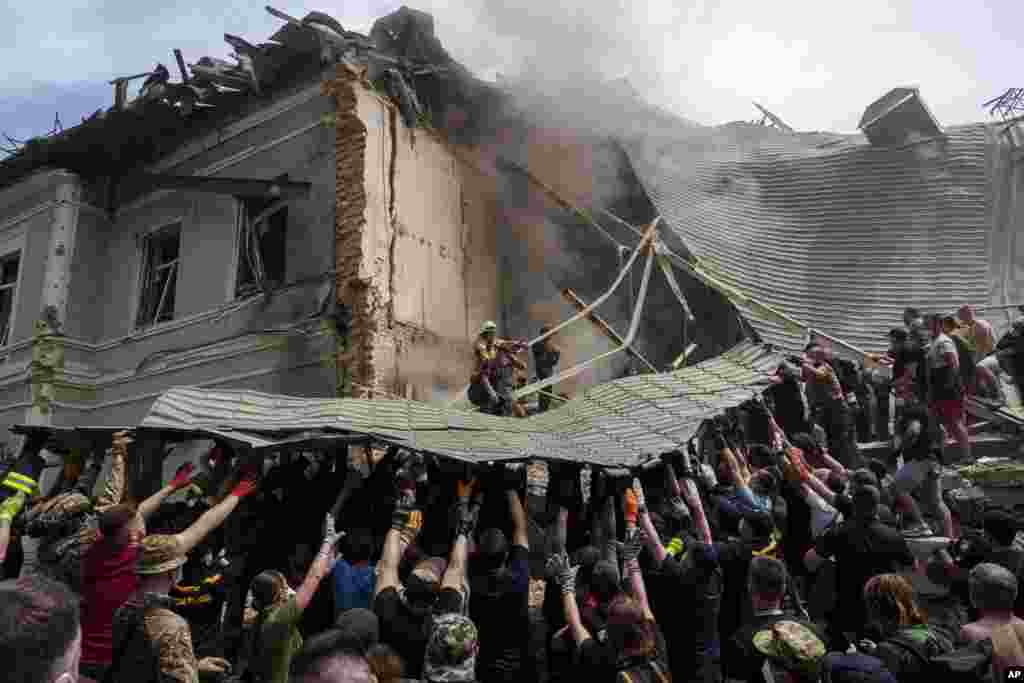 Rescuers and volunteers work at the site of Okhmatdyt children’s hospital hit by Russian missiles, in Kyiv, July 8, 2024. A major Russian missile attack across Ukraine killed at least 20 people and injured more than 50, officials said, with one missile striking a large children’s hospital in the capital. 