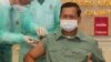 Cambodia's Lt. Gen. Hun Manet, a son of Prime Minister Hun Sen, thumbs up as he receives a shot of the COVID-19 vaccine at Calmette hospital in Phnom Penh, Cambodia, Wednesday, Feb. 10, 2021. (AP Photo/Heng Sinith)