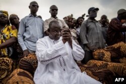 Adama Barrow, the flag-bearer of the coalition of the seven opposition political parties in Gambia, greets supporters during a gathering in the Buffer Zone district of Talinding, Nov. 29, 2016, on the last day of the presidential campaign in Gambia.