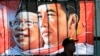 Seorang pria tampak duduk di dekat spanduk yang memasang gambar wajah dari Presiden Joko Widodo dan Wakil Presiden Ma'ruf Amin di salah satu sudut jalanan di Jakarta pada 20 Oktober 2019. (Foto: AP/Tatan Syuflana)