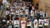 Para demonstran Irak dari Kota Nassiriya membawa poster orang-orang yang terbunuh dalam demo anti-pemerintah yang masih terus berlangsung di Baghdad, Irak, 6 Desember 2019. (Foto: Reuters)