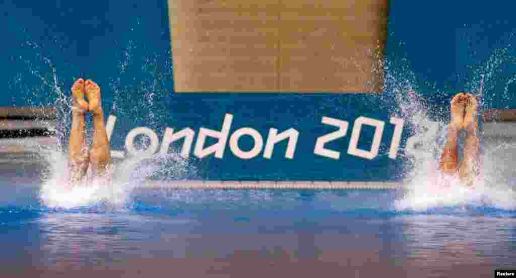 China's Cao Yuan and Zhang Yanquan perform a dive in the men's synchronised 10m platform final at the Aquatics Centre.
