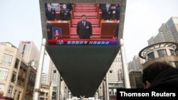 Giant screen shows Chinese President Xi Jinping attending the closing session of the National People's Congress (NPC) at the Great Hall of the People, in Beijing, March 11, 2021.