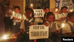 Students hold candles as they pray during a candlelight vigil for a gang rape victim, who was assaulted in New Delhi and later died, in Ahmedabad, India, December 31, 2012.