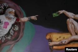 A reinterpreted version of Michelangelo's "Creation of Adam" is pictured on a ceiling inside the newly opened Kitsch Museum in Bucharest, Romania, May 5, 2017.