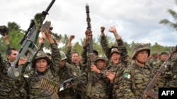 MILF rebels celebrate the signing of the peace agreement during a rally at Camp Darapanan, Sultan Kudarat town, in southern island of Mindanao, March 27, 2014.