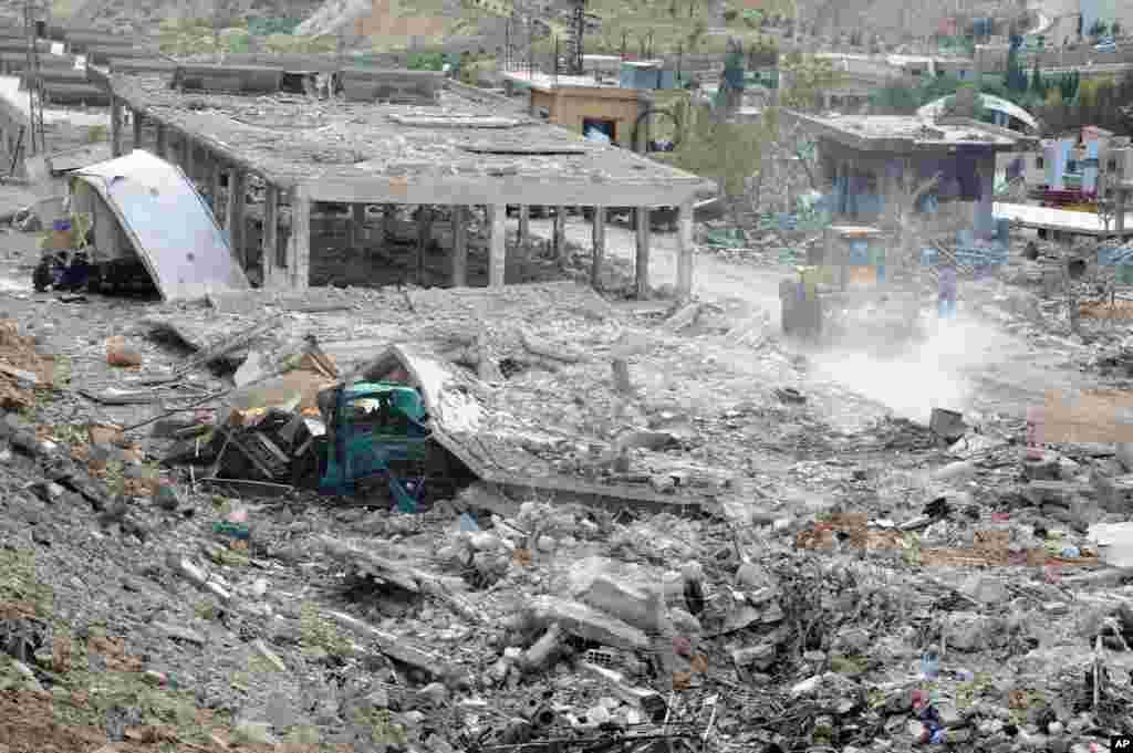 This photo released by the Syrian official news agency SANA shows damaged buildings wrecked by an Israeli airstrike in Damascus, May 5, 2013.
