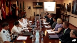 FILE - Philippine and U.S. negotiators discussing U.S. troop presence in the Philippines are seen meeting at the Department of National Defense headquarters in Quezon city, north of Manila.