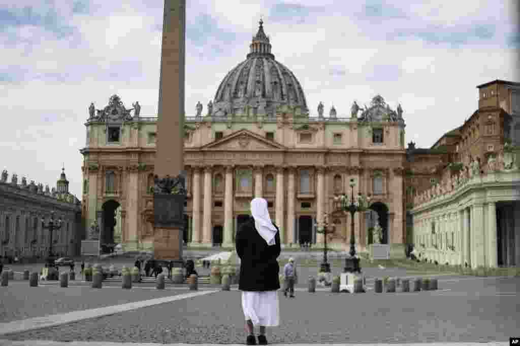 A nun stands in St. Peter's Square at the Vatican.