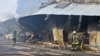 Пожарные тушат пожар после атаки беспилотника на склад в Одессе, Украина, 11 марта 2025 года.