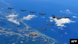 This handout photo taken Sept. 18, 2017 and provided by the South Korean Defense Ministry in Seoul shows U.S. and South Korean fighter jets flying over South Korea during a joint military drill aimed to counter North Korea’s latest nuclear and missile tes
