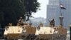 Egyptian soldiers stand guard as they close one of the entrances to Tahrir Square in Cairo, Aug. 23, 2013.