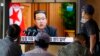 People watch a TV screen showing North Korean leader Kim Jong Un in a news program, at Seoul Railway Station in Seoul, South Korea, Sept. 30, 2021.