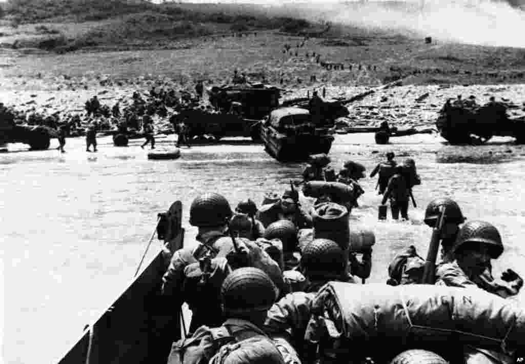 Allied forces using amphibious trucks follow foot troops ashore during the early invasion of the Normandy coast, June 6, 1944. 