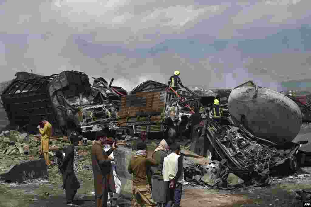 Firefighters extinguish a fire following an overnight ablaze in which several fuel tankers caught fire at Qala-e-Murad Bek area on the outskirts of Kabul, Afghanistan.