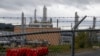 FILE - The MarkWest Bluestone Gas Processing Plant is visible behind the roadside fencing in Evans City, Pa., Oct. 17, 2019.